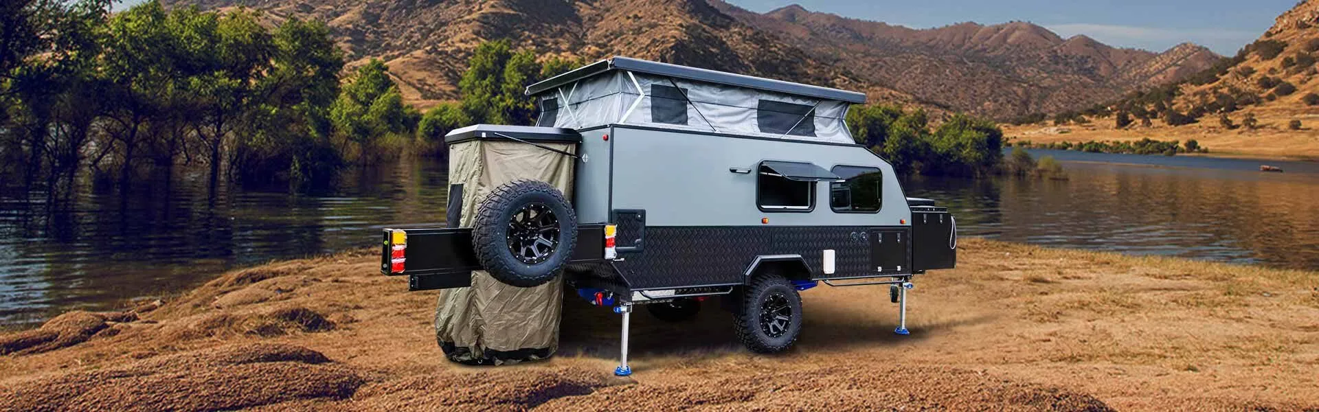 Off-road popup camper parked by a mountain lake