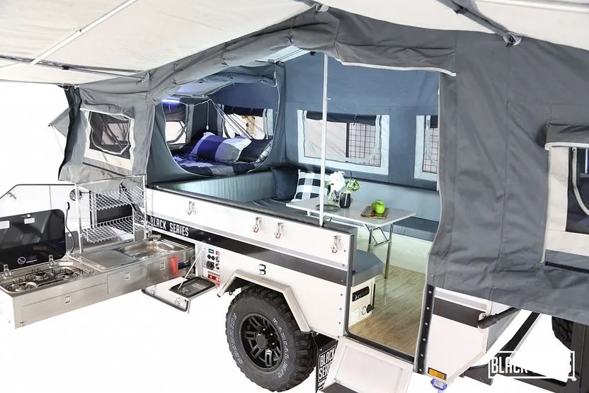 Black Series off-road popup camper with outdoor kitchen and electrical setup